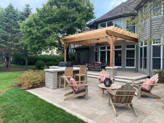 Outdoor living area with built in grill , bar area and pergola