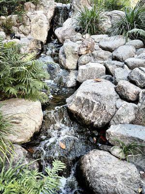 The "rushing fall of water in the upper portion ... represents the struggles of the Issei."