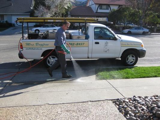 Powerspraying crack and crevices of driveways and sidewalks