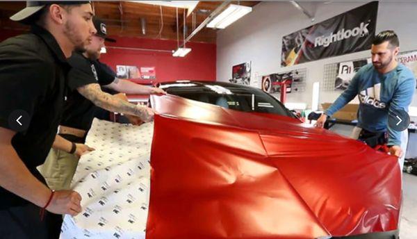 Students learn by doing in vehicle wrap class.