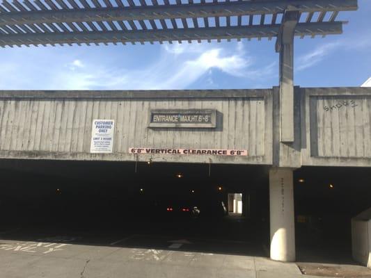 Entrance to covered parking structure. Watch out for broken glass. Sign of frequent car break ins.