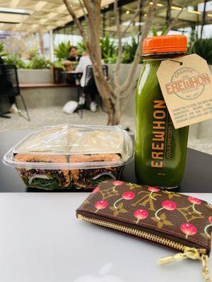 Erewhon packaging - Organic Just Greens juice & Salmon Banh Mi Collard Green Wrap (with dressing on side) at outside garden area