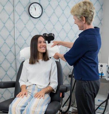 This is Dr. Martha Koo helping a patient get comfortable and ready for TMS therapy at our Manhattan Beach Location.