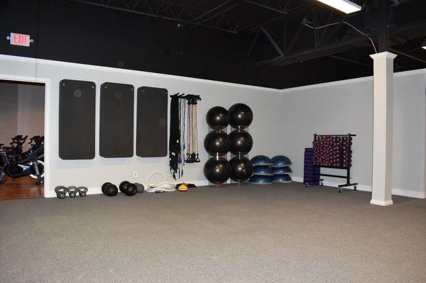 Large multi-purpose room with shock-absorbent flooring for fitness classes including HIIT, Yoga, TRX, and more!