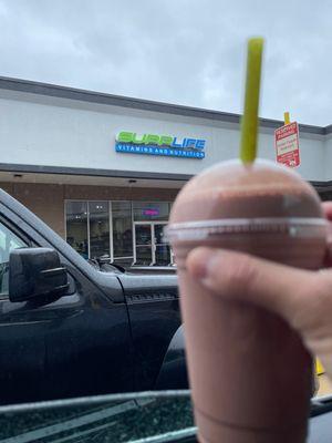 Chocolate protein with water and strawberries