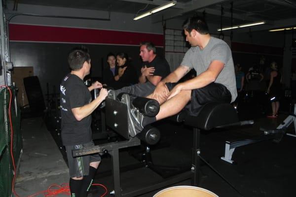 Coach Mike teaching the Essentials Class how to properly use the GHD's.