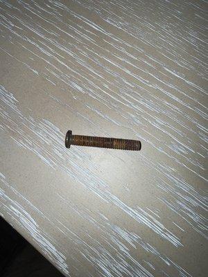 A rusted screw that fell out of our brand new table