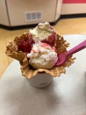 2 scoops on a waffle cup with strawberry topping