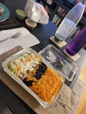 Burrito bowl with Carnitas with chips, salsa, and guac to go.