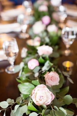 Loose garlands on farm tables. Flowers and decor by J. Morris Flowers. Gorgeous farm table by Stone Tower Winery.