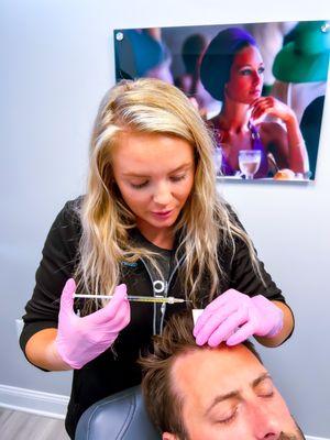 Tori Thursby, RN performing PRP hair treatment.