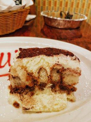 Tiramisu -- Three layers of lady fingers soaked in coffee and liqueur, filled with zabaglione cream, topped with grated Belgium Chocolate