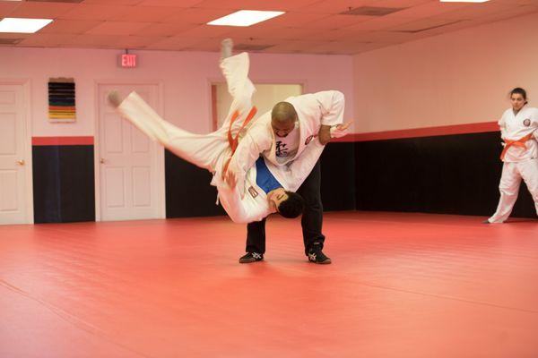 Adult class working on major hip throw.