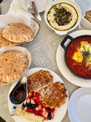 Hummus with mushroom, pita, waffles, shakshuka