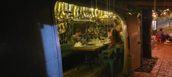 Diners can head to Hullaballo's charming back patio to sit at regular tables or inside this vintage Airstream camper.