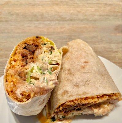 Build your own Burrito. Al pastor, spanish rice, refried beans, cheese, onion, cilantro, lettuce, & cabbage. Baja sauce & sour cream added.