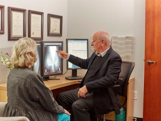 Dr Bigg MDJD  reviewing results with the patient after they have had a mammogram