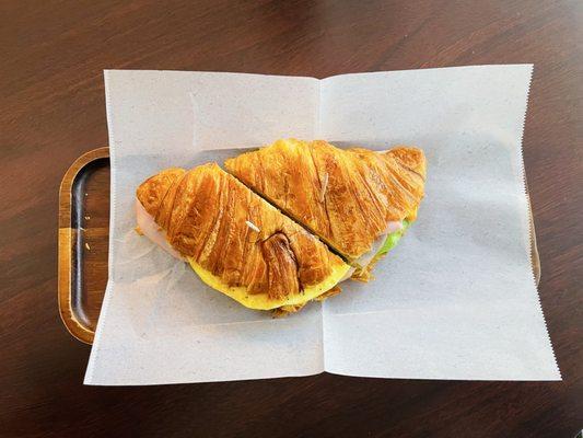 Croissant Sandwich (Ham, Egg, Cheddar, Avocado, Garlic Aioli on an Artisan Croissant).