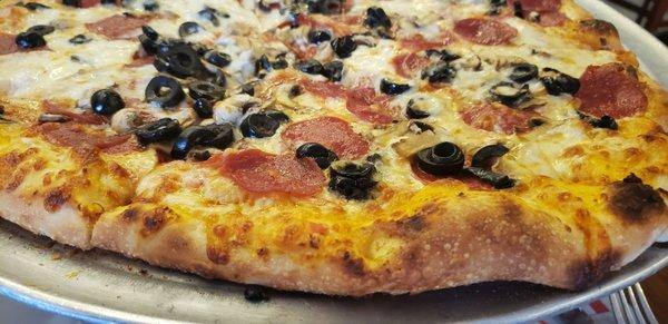 Pepperoni, mushrooms, olives, garlic and extra cheese. Garlic is the most important thing!