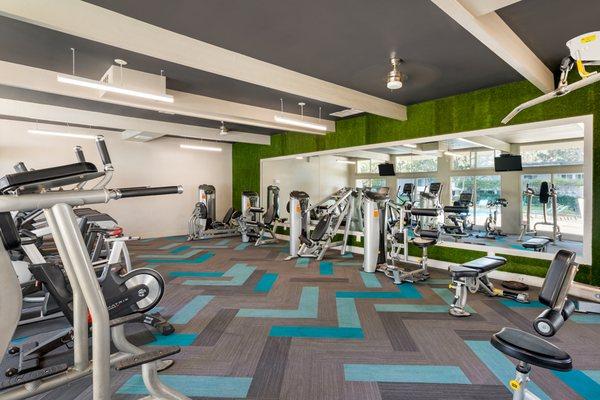 Fitness center with cardio and strength training equipment.