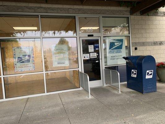 Post office, mailing drop box by the exit door.