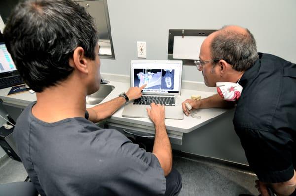 Dr. Levy and Dr. Simon review 3D renderings of implants. We are implant specialists!