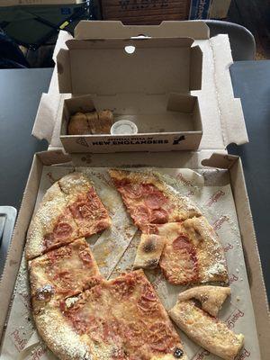 The next day; crusts and 85% of the pizza remain due to being inedible.