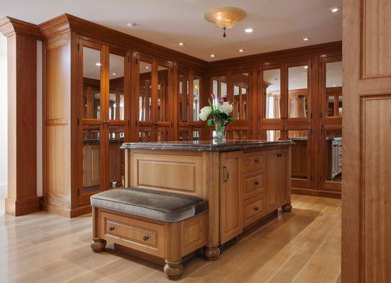 A custom cherry master closet designed and fabricated by American Artisans.