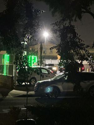 10pm parking lot jam. Love the headlights and flood light coming into my front room.