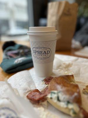 Plain bagel with scallion cream cheese, capers, and turkey bacon