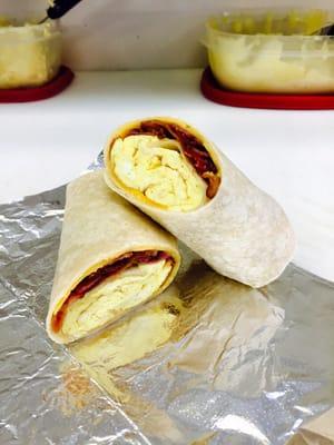 Bacon, egg, and cheese on a white flour wrap