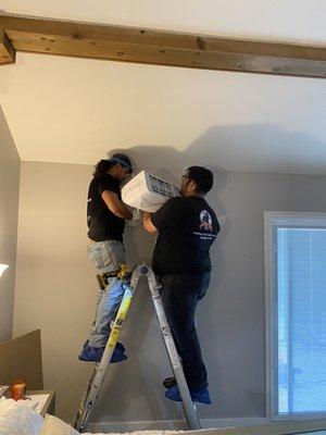 Hanging a ductless evaporator for additional cooling needed in a home.