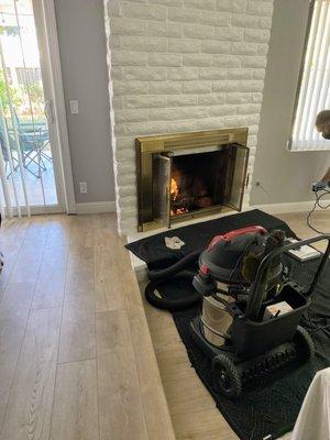 Danny testing the fireplace with a fire; the pic shows how he's laid out his equipment and how much space he needs to do his work.