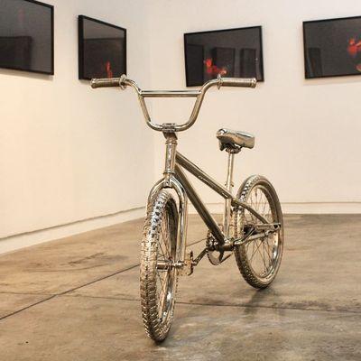 Chrome bike by @jillelizabeth_gower in an art gallery.