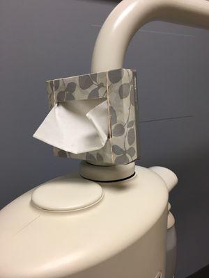 High tech rubber band holding Kleenex to most uncomfortable dental chair ever. They put that there so no one has to actually help you.