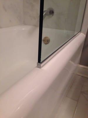 U-channel base installed on the top of the tub with a chrome end cap to finish it off.