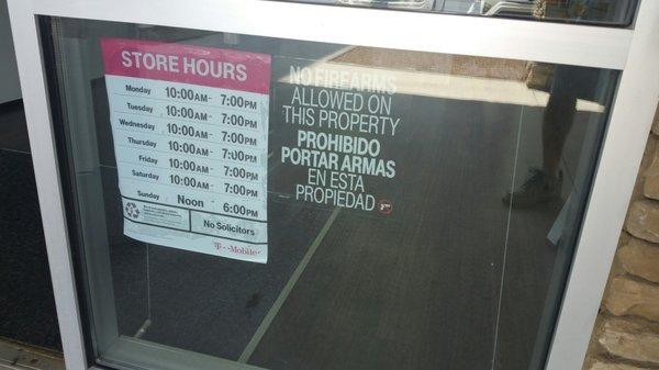 Store hours and no firarms allowed on property notice.