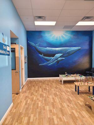 Sick Waiting Area with mural painted by one of the pediatricians.