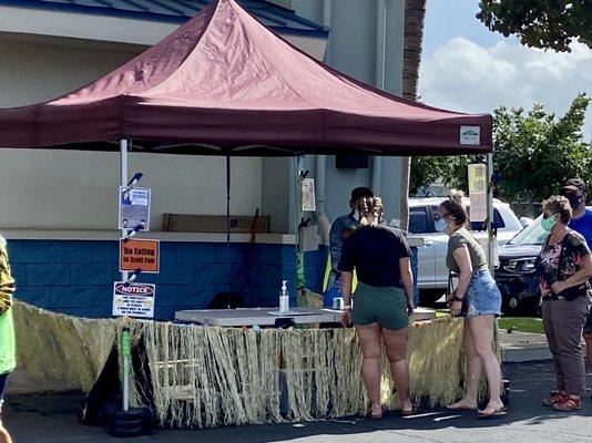 Checking temperature of everyone entering swap meet area.