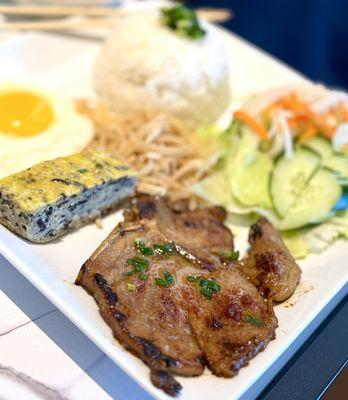 Pork chop with meatloaf, shredded pork, eggs, salad, rice