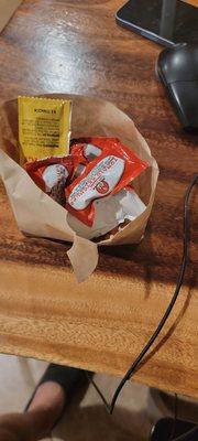 fry bag was filled with half an order of fries all smashed and with ketchup packets in the bag on top of the fries.