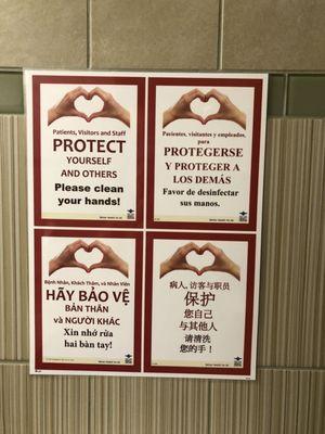 Hand washing signs in restroom in English, Spanish, Vietnamese, and maNdarin