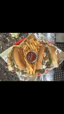 Philly cheesesteak sandwich with fries