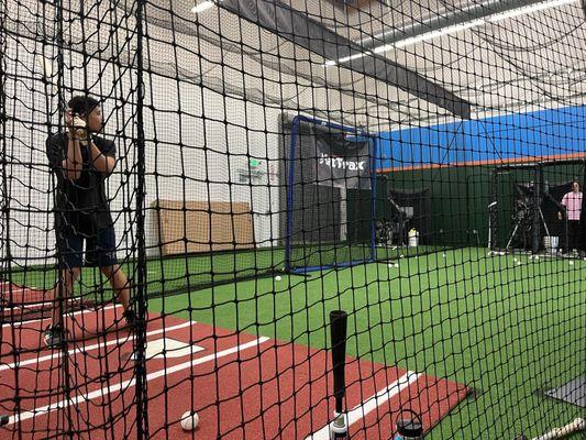 Hitting in the cage equipped with HitTrax, they also have Rapsodo if you love analytics.