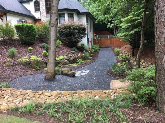 After photo. Variation in color and materials. French drains underneath path in certain areas. The area is beautiful and functional.