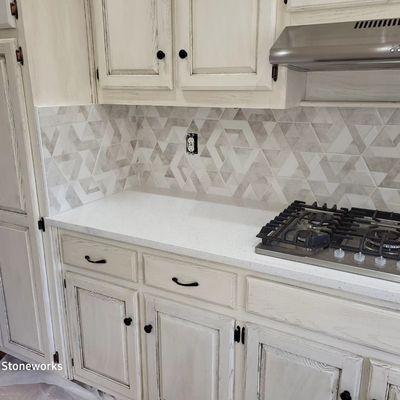 Olympic PQ Quartz countertops with a 3d Hexagon backsplash.