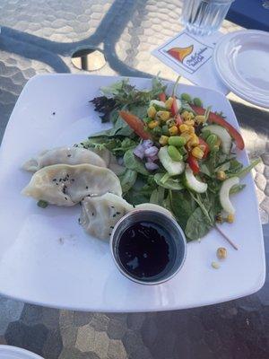 Potstickers and some type of wasabi sauce (comes with 4 potstickers)