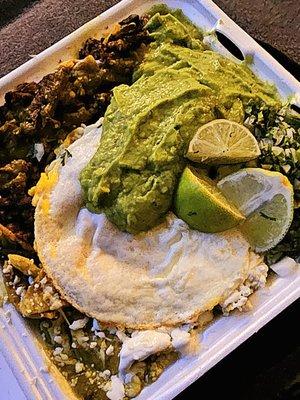 Chilaquiles with asada, medium egg with a heap of avocado salsa. Soooo good!