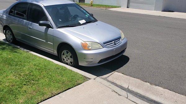 My car parked perfectly legally on the street, with the note threatening that it will probably get hit if parked there.