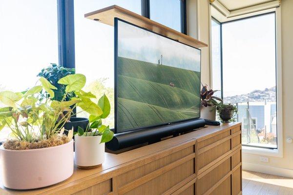 This TV rises from the cabinet below! This leaves no TV in sight when not in use! When it's time to watch, the TV rises with a Sonos Arc!